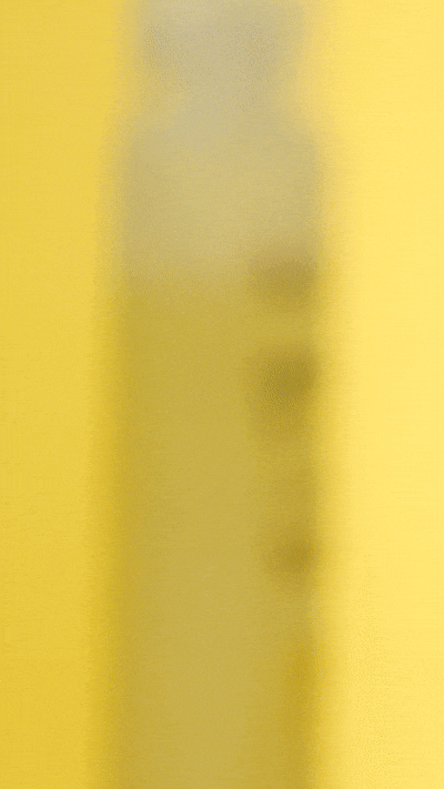 Lieve Care luxury lemon lime body wash in a clear bottle with a bright yellow background