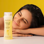 Load image into Gallery viewer, Lieve Care luxury lemon lime body wash in a clear bottle next to a smiling woman against a bright yellow background
